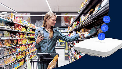 LANCOM Wi-Fi 7 pour la vente au détail Une femme dans un supermarché utilise un smartphone pour sélectionner un produit dans un rayon. Au premier plan, un point d'accès LANCOM LX-7200.