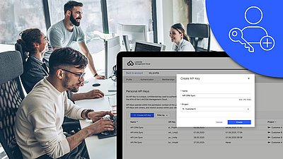 Abbildung mit Fokus auf Screenshot der neuen API-Anwendung auf einem Monitor, Icon und Menschen im Büro im Hintergrund 